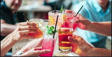Friends toasting with colorful cocktails